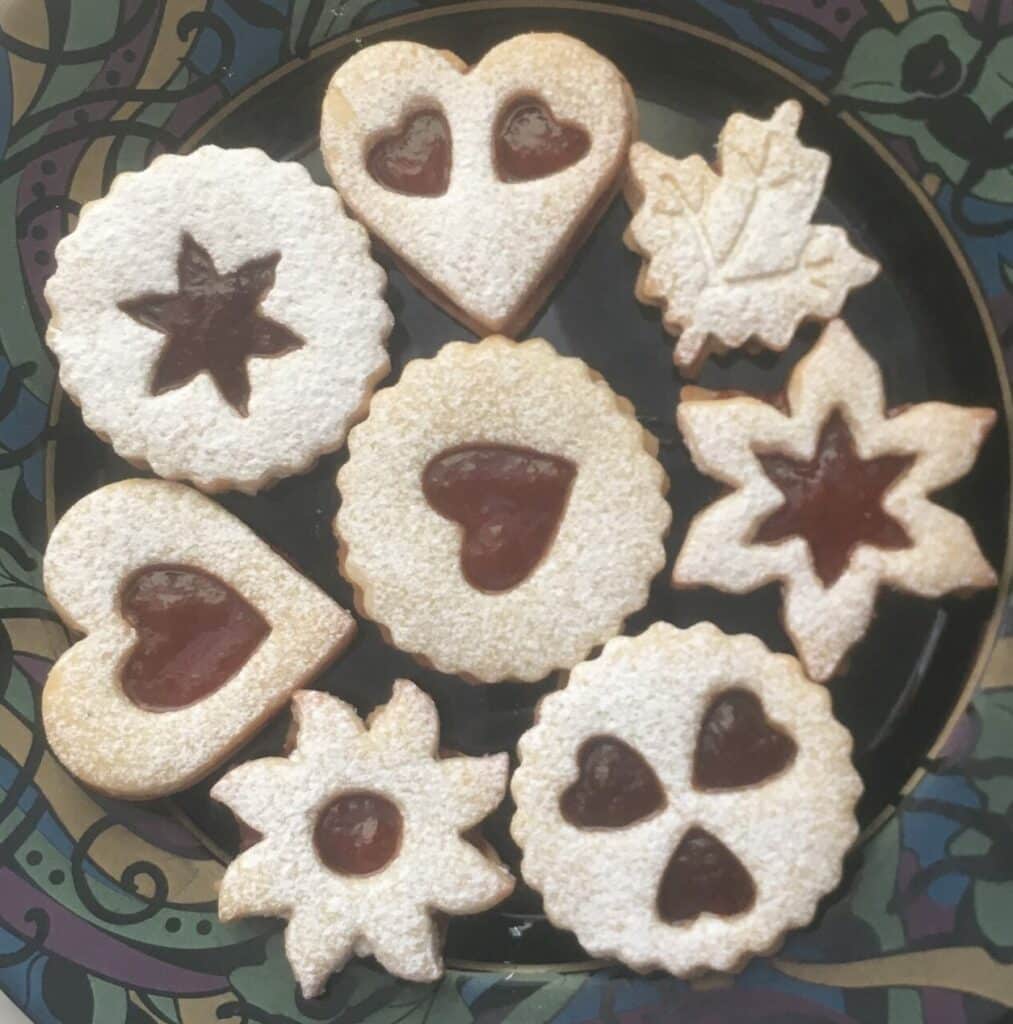 Jam filled Linzer cookies of various shapes and sizes.