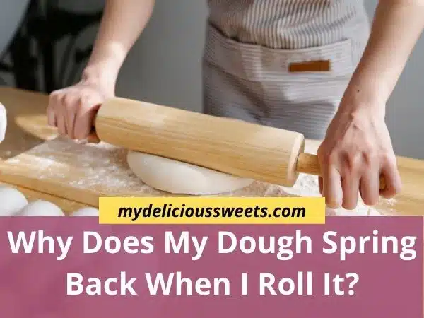Someone is rolling the dough with a rolling pin on a floured wooden surface.